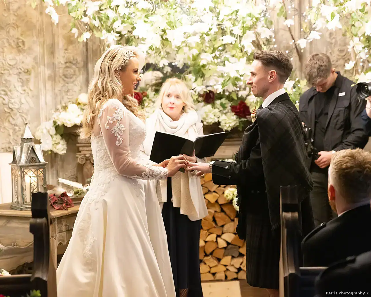 Yvonne placing a ring on John’s hand during their wedding ceremony