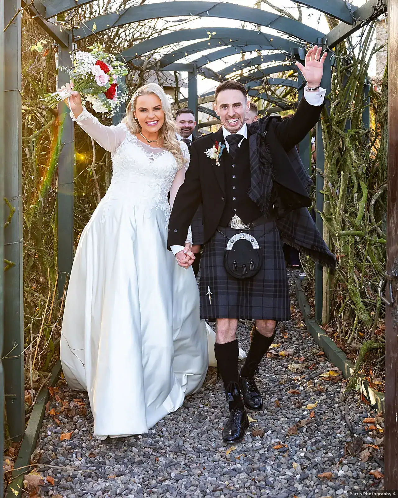Yvonne and John celebrating on the walkway from the ceremony room at Branxholm Park