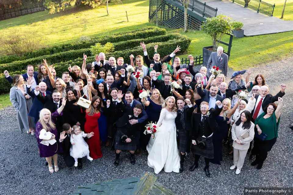 Yvonne and John with their wedding guests outside Branxholm Park